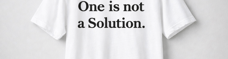 White t-shirt with large black quotation marks printed on the front