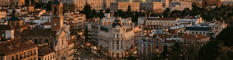Madrid skyline with historic buildings and people walking at sunset